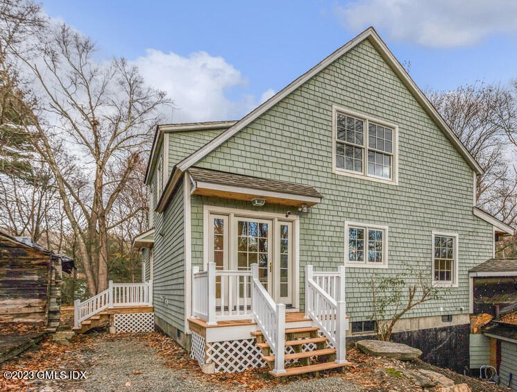 96 Cat Rock Road Cos Cob, CT 06807 - Photo 31 of 38 a front view of a house with a yard