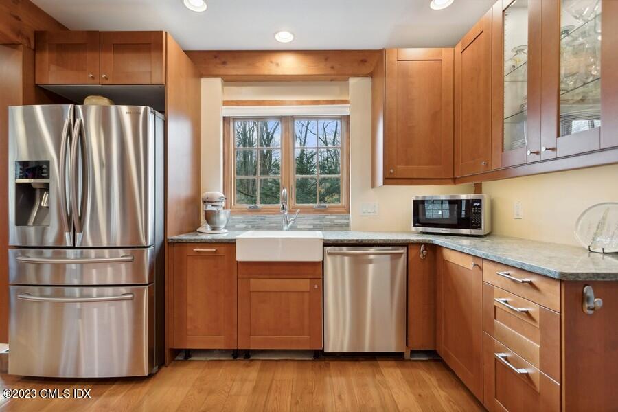 96 Cat Rock Road Cos Cob, CT 06807 - Photo 7 of 38 a kitchen with stainless steel appliances granite countertop a refrigerator sink and wooden cabinets