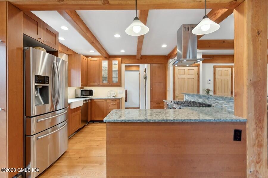 96 Cat Rock Road Cos Cob, CT 06807 - Photo 8 of 38 a kitchen with stainless steel appliances granite countertop a refrigerator a oven a sink with island and chairs