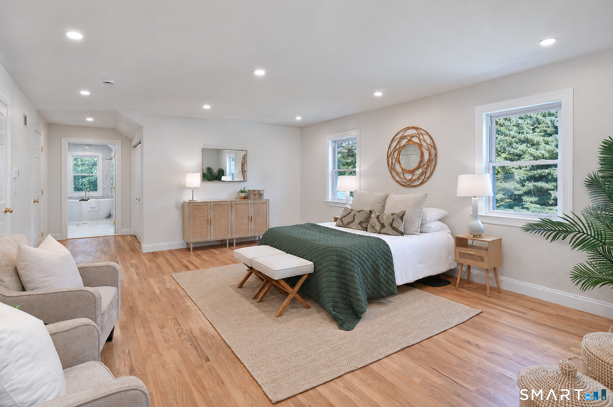 34 Rimmon Road Woodbridge, CT 06525 - Photo 24 of 40 Bright and inviting primary bedroom with hardwood flooring and plenty of room to unwind.