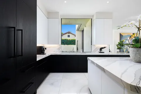 a spacious bedroom with a bed a couch and a flat tv screen