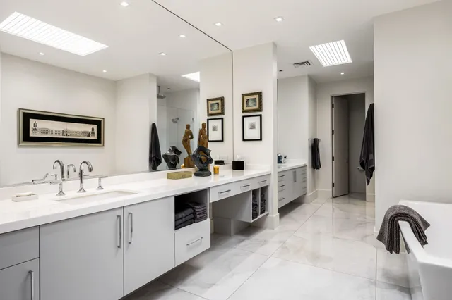 a front view of a house with garden and trees