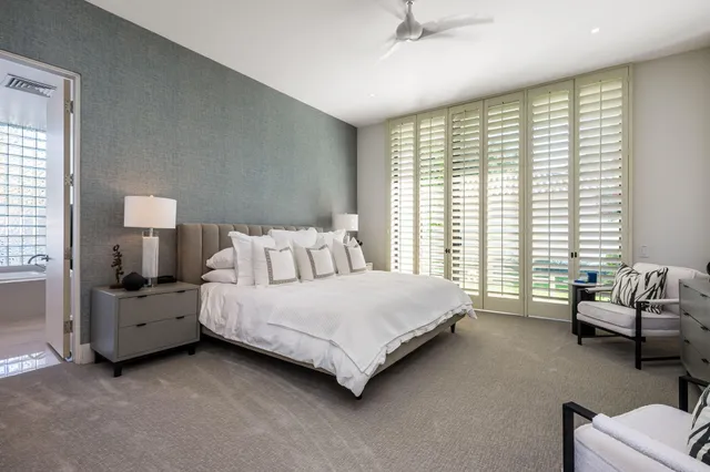 a front view of a house with a garden and swimming pool