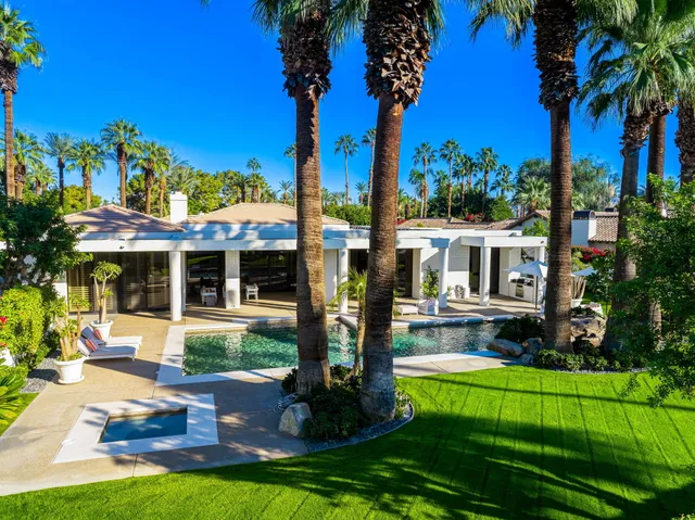 a view of a house with swimming pool and porch