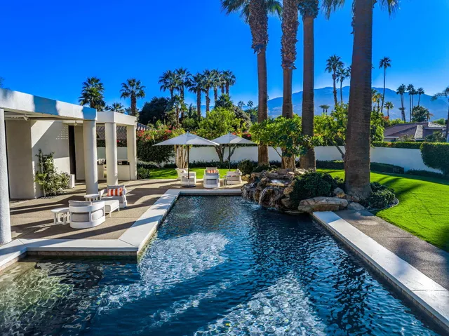 a living room with furniture large window and flat screen tv