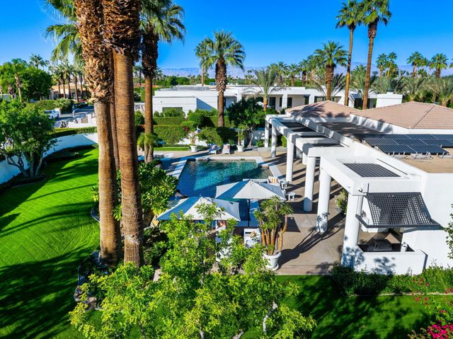 a living room with furniture a fireplace and a large window