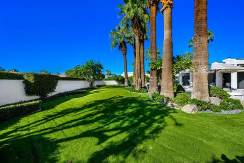 a view of a house with swimming pool and sitting area