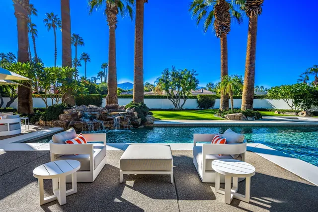 a front view of a house with a yard patio and fire pit