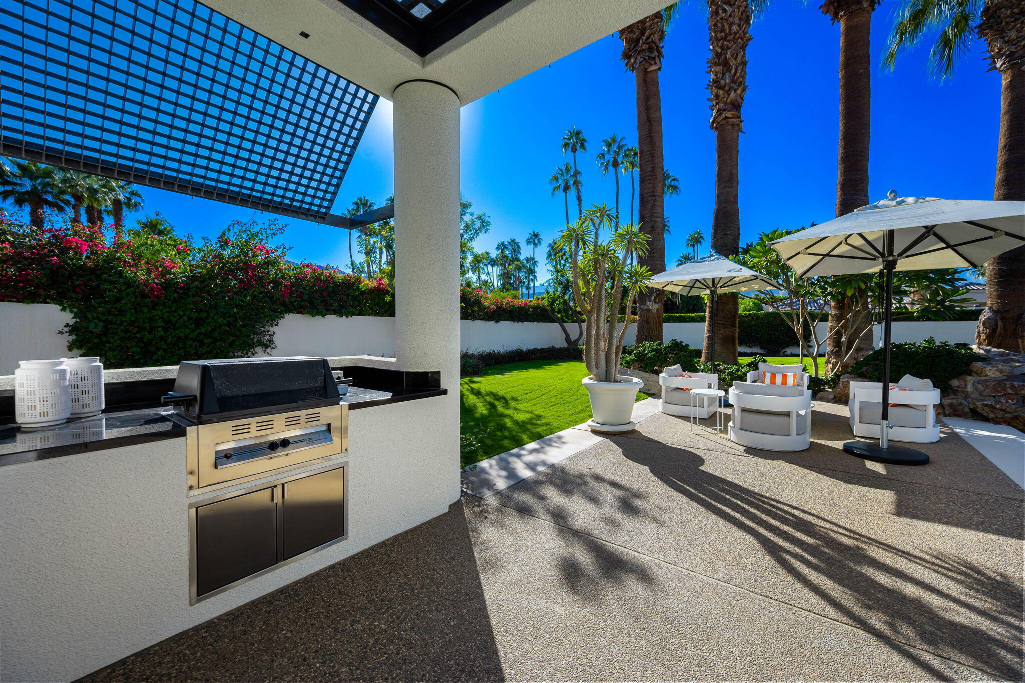 40590 Morningstar Road Rancho Mirage, CA 92270 - Photo 50 of 76 a view of a patio with couches table and chairs under an umbrella