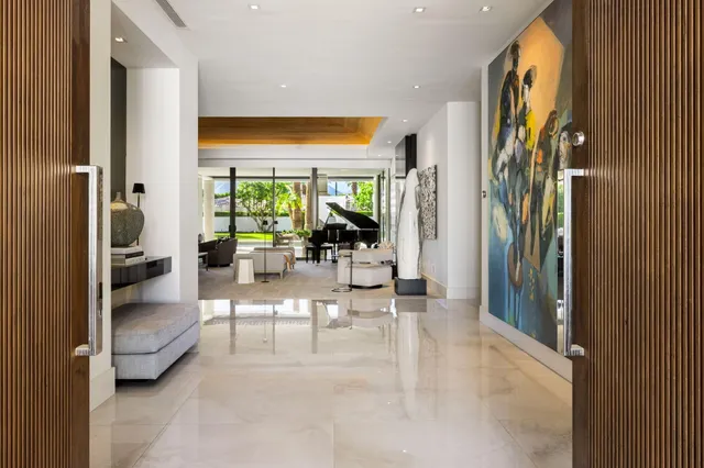 a view of a dining room with furniture and chandelier