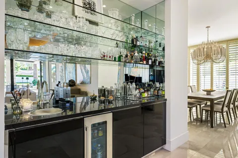 a large kitchen with kitchen island granite countertop a large counter top and stainless steel appliances