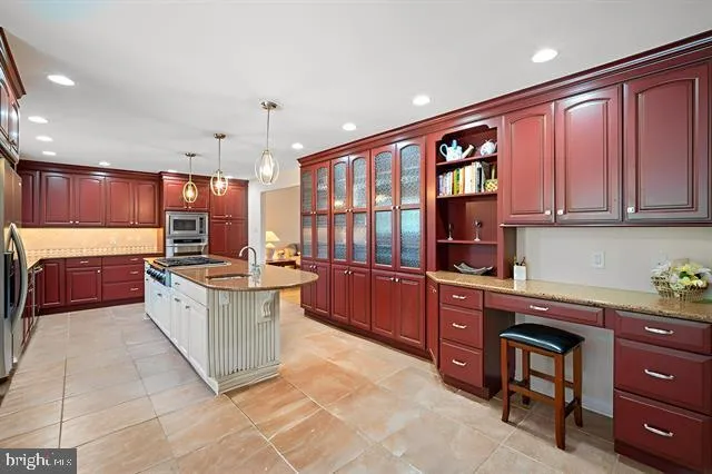 a large kitchen with stainless steel appliances wooden cabinets and a sink