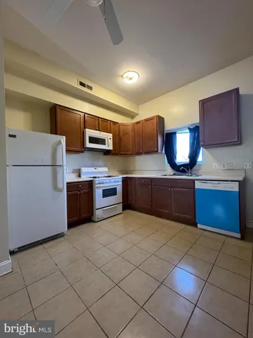 a kitchen with stainless steel appliances a stove sink and cabinets