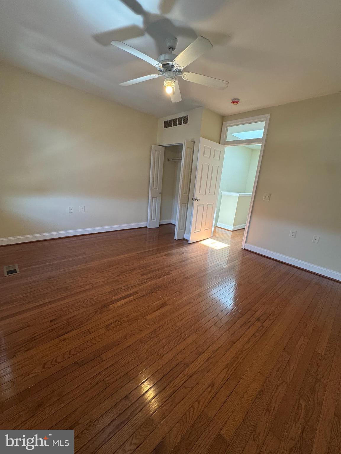 808 East Preston Street Baltimore, MD 21202 - Photo 5 of 20 an empty room with wooden floor and a ceiling fan