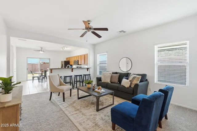 a living room with furniture a window and a potted plant