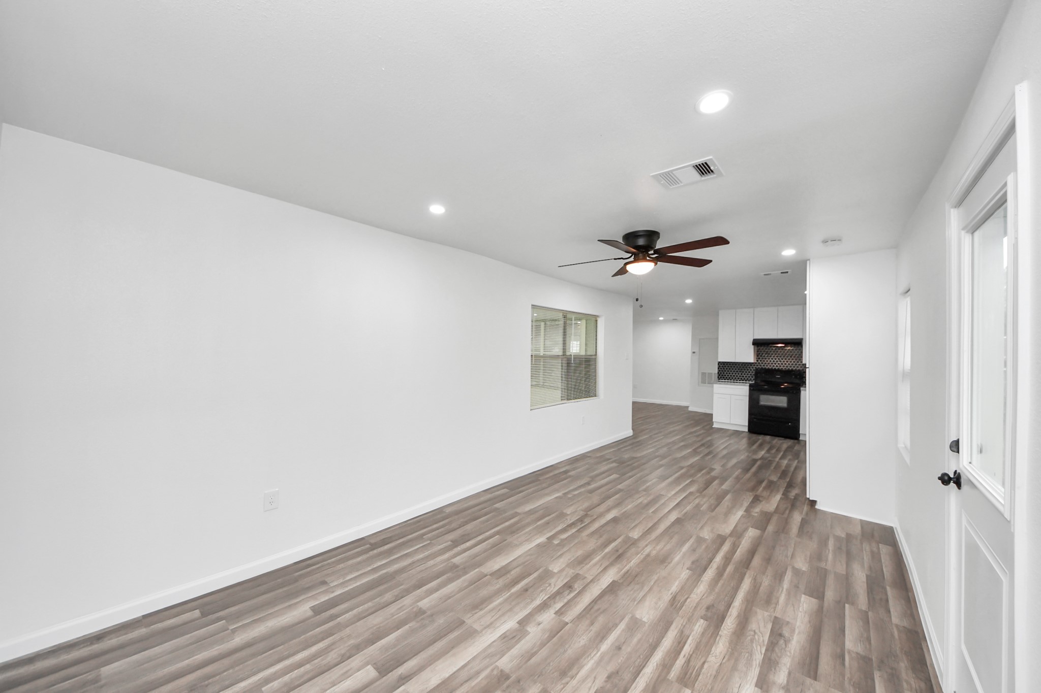 207 East Defee Avenue Baytown, TX 77520 - Photo 15 of 36 wooden floor in an empty room with a window