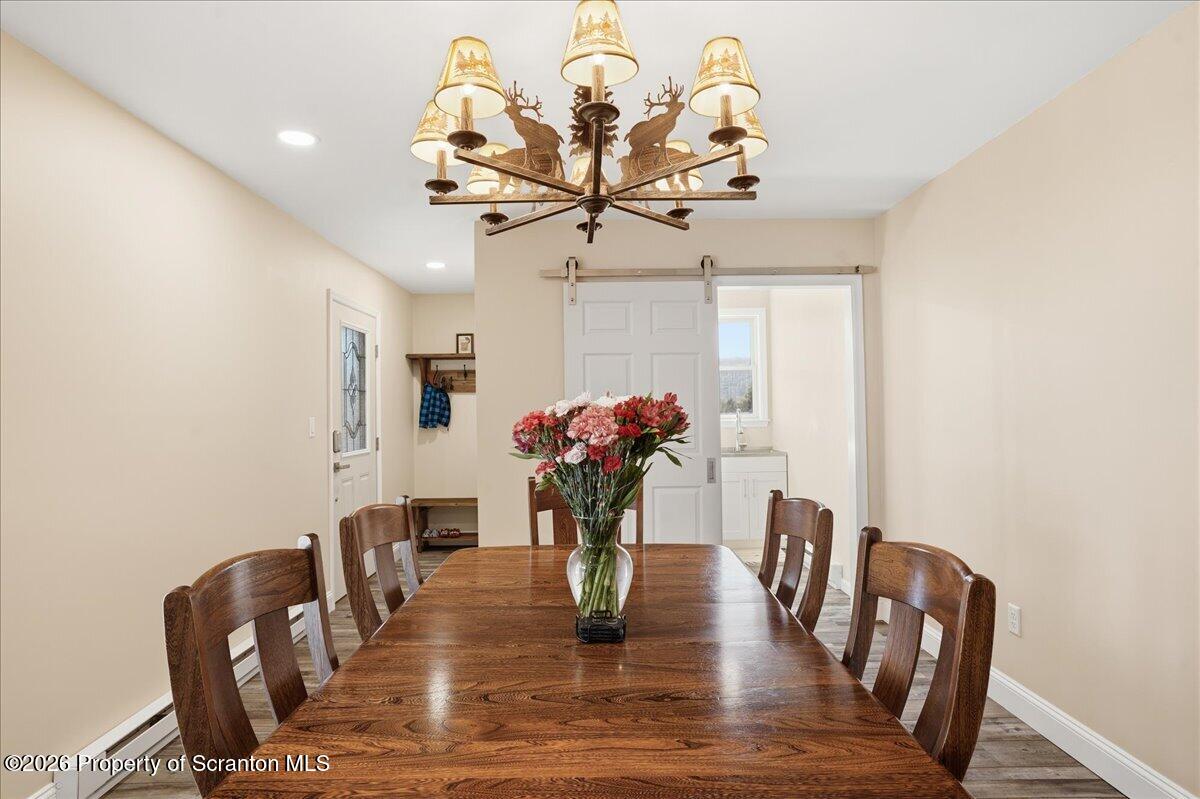 6105 State Rte 2012 Union Dale, PA 18470 - Photo 18 of 79 a dining room with furniture potted plants and wooden floor
