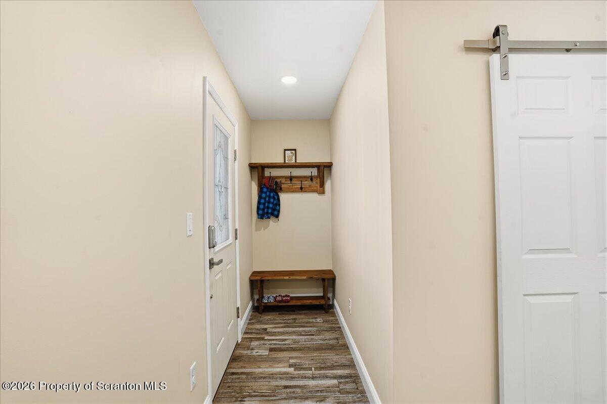 6105 State Rte 2012 Union Dale, PA 18470 - Photo 21 of 79 a view of a hallway with wooden floor and a bathroom