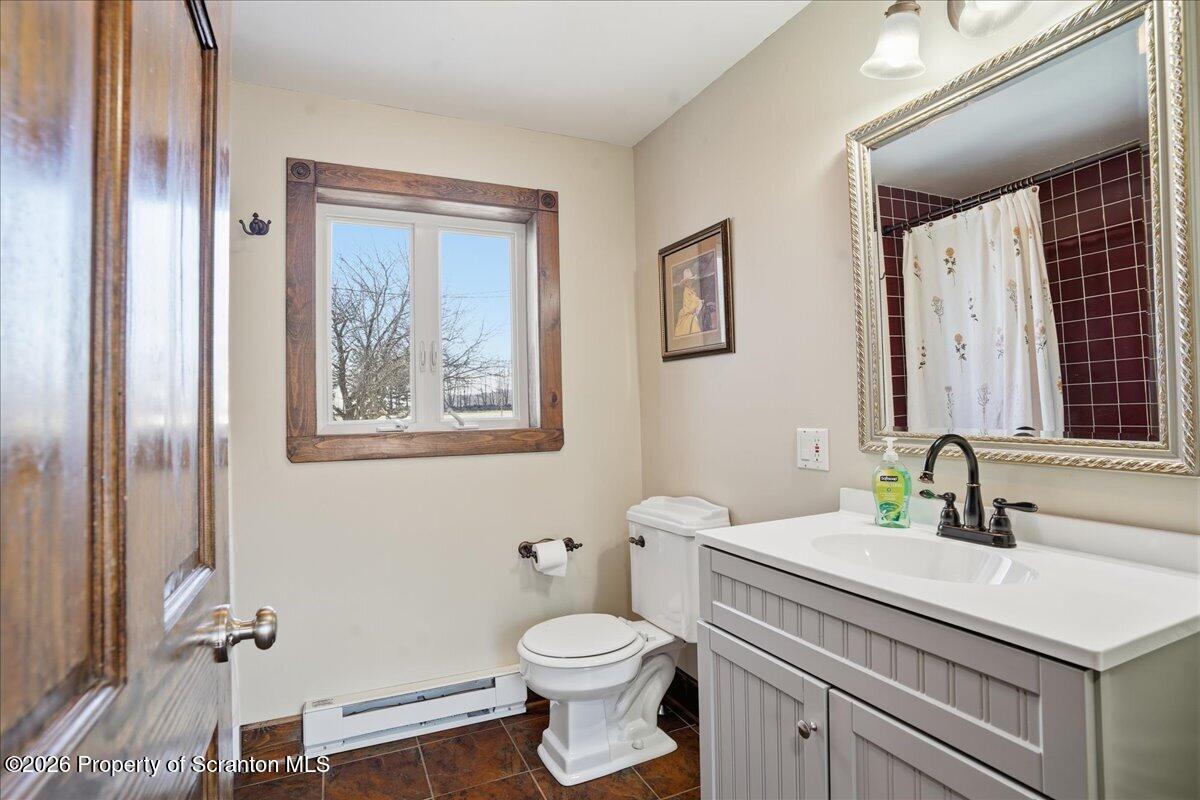 6105 State Rte 2012 Union Dale, PA 18470 - Photo 24 of 79 a bathroom with a toilet a sink and mirror