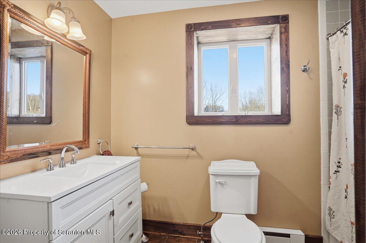 6105 State Rte 2012 Union Dale, PA 18470 - Photo 41 of 79 a bathroom with a toilet sink and mirror