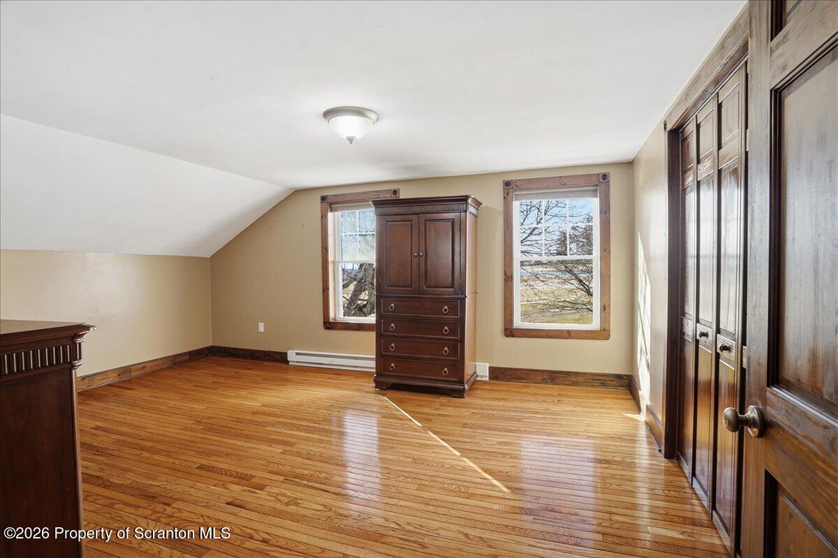 6105 State Rte 2012 Union Dale, PA 18470 - Photo 42 of 79 an empty room with wooden floor cabinet and windows