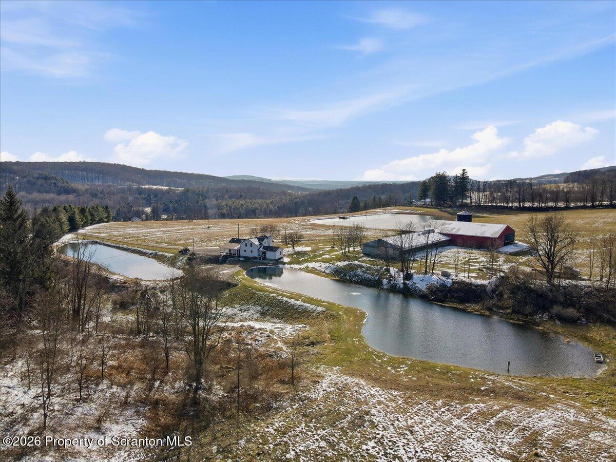 6105 State Rte 2012 Union Dale, PA 18470 - Photo 70 of 79 a view of a lake with boats and trees in the background