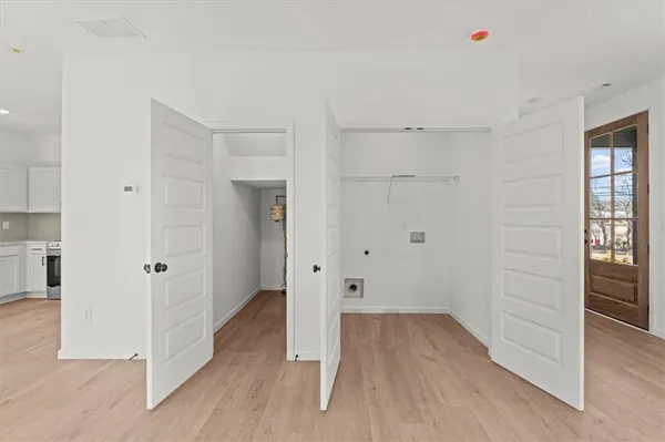 a view of a room with wooden floor