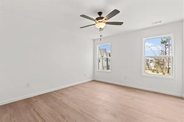 wooden floor in an empty room with a window