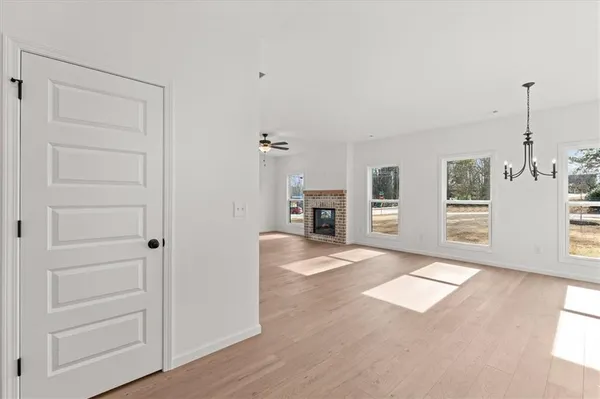 an empty room with kitchen appliances and windows
