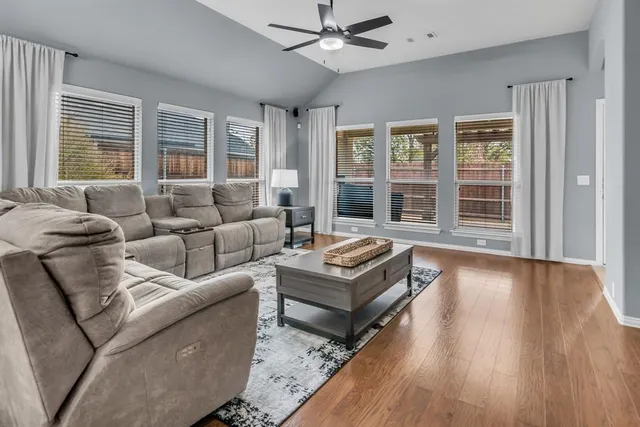 a kitchen with granite countertop stainless steel appliances a table chairs microwave and refrigerator