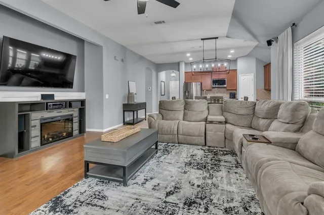 a living room with furniture ceiling fan and a window