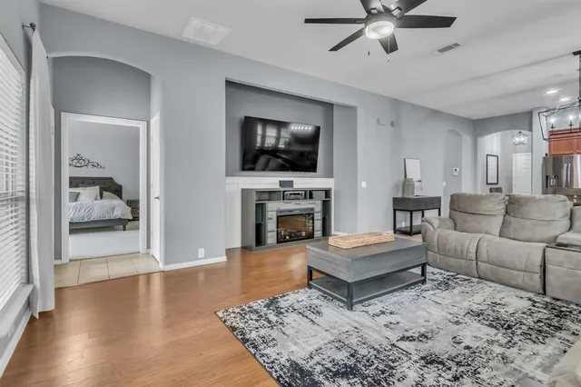 a living room with furniture a flat screen tv and a fireplace