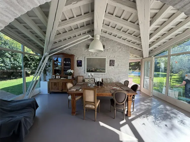 a view of a patio with a table chairs and a backyard