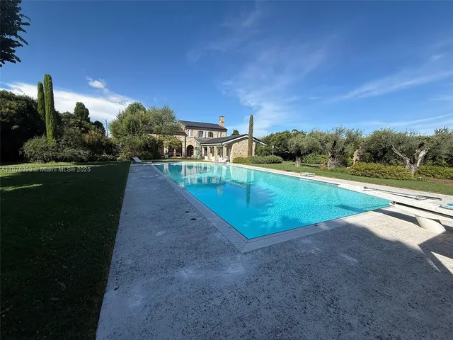 a view of a swimming pool with a yard