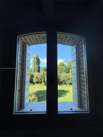 a bedroom with a bed and a mirror