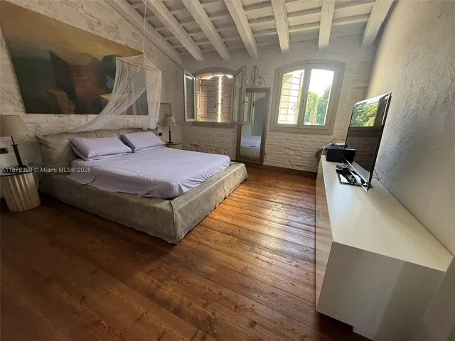 a bathroom with a sink and mirror with toilet