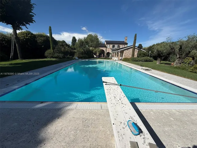 a view of a backyard with swimming pool