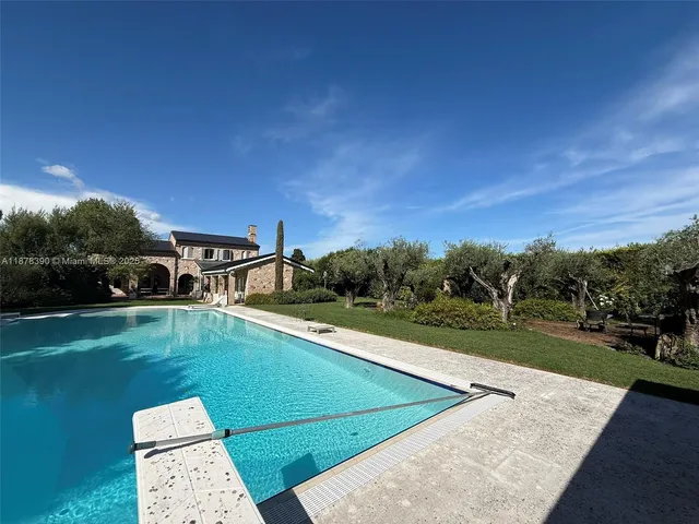 a view of a swimming pool with a yard