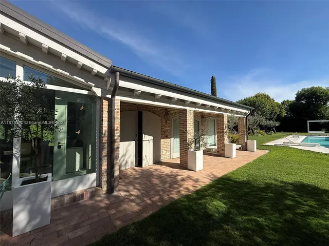 a view of a house with backyard porch and sitting area