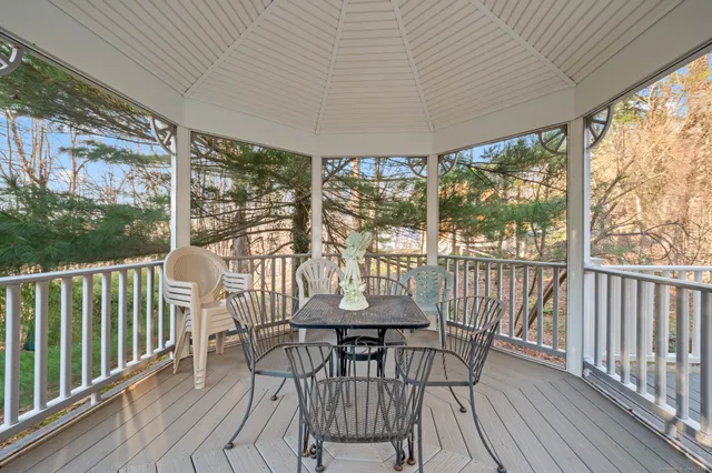 a view of a chairs and table in the balcony