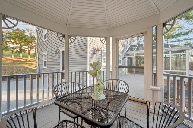 a view of a chairs and table in the balcony