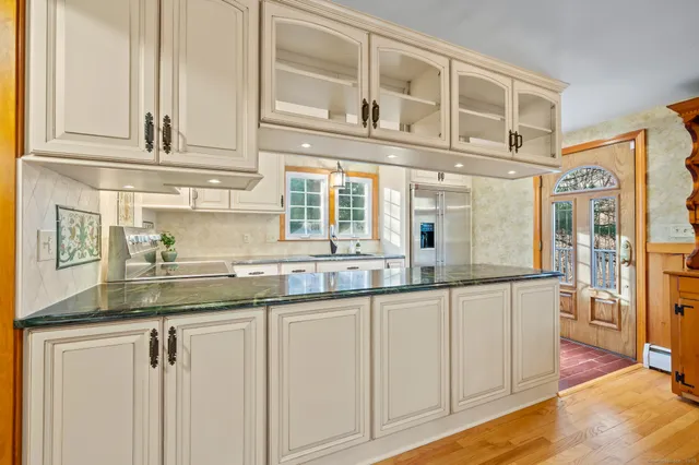 a kitchen with stainless steel appliances granite countertop a sink and cabinets