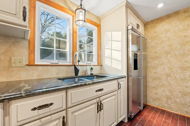 a kitchen with granite countertop a sink and a window