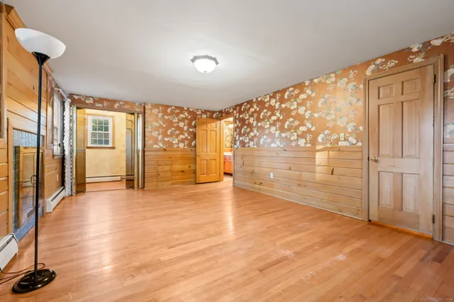 a view of an empty room with glass door and a window