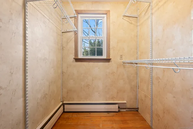 a view of walk in closet with empty racks
