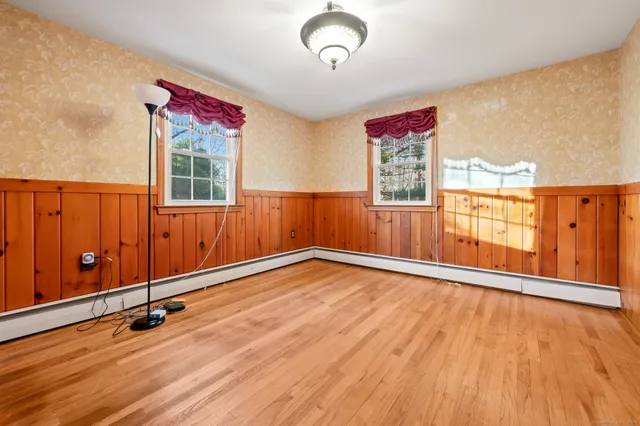wooden floor in an empty room with a window