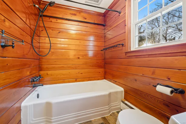 a bathroom with a bathtub and shower