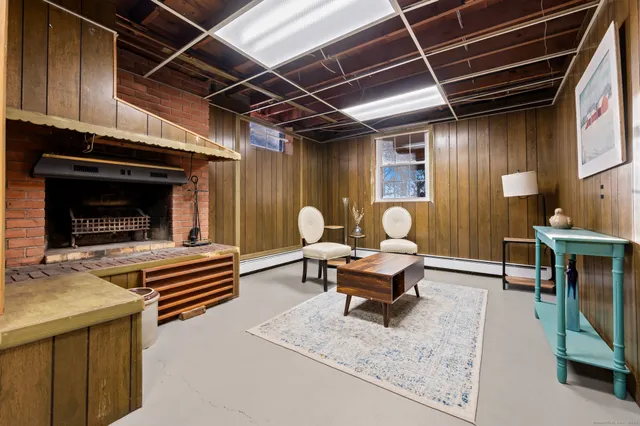 a living room with furniture a fireplace and a table