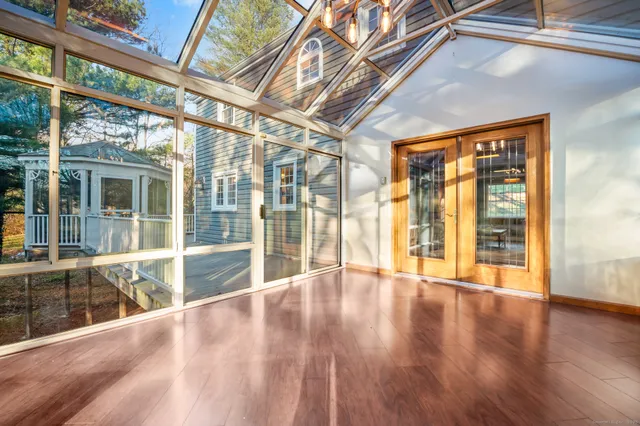 a view of an entryway with wooden floor