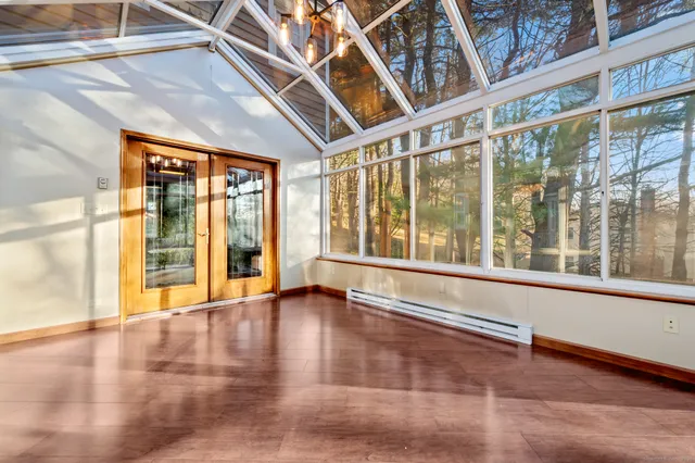 a view of an entryway with wooden floor